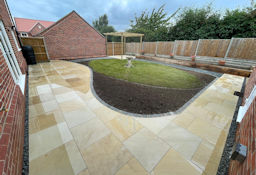 Eliptical Lawn with wrap around patio and planting
