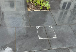 Porcelain patio with inset planting and access panel cover
